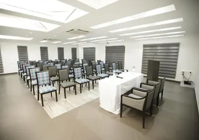 a large room with a white table and chairs at Regency Palani by GRT Hotels in Palani