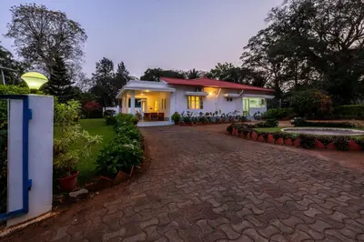 a house with a brick driveway in front of it at Ama Plantation Trails Coorg in Gonikoppal