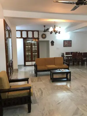 a living room with a couch and a table at Sannidhi Home stay in Guruvāyūr