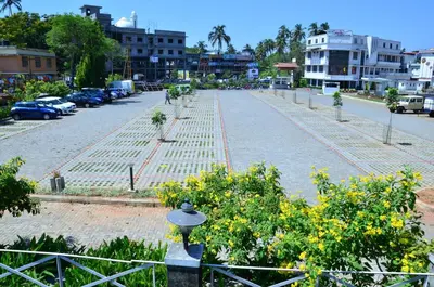 an empty street with trees and a fence at Hotel Merlin International in Trichūr