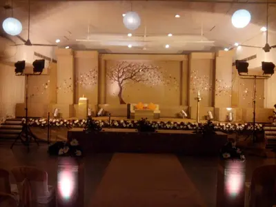 a room with a stage with a tree on the wall at Hotel Merlin International in Trichūr