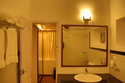 a bathroom with a sink and a mirror at The Tamarillo in Ooty