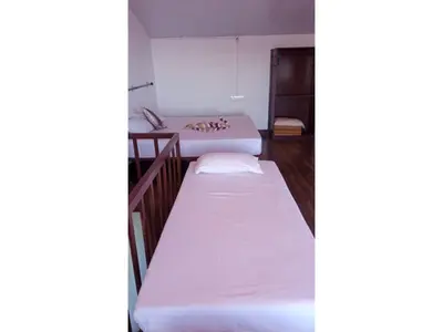 two beds in a room with white sheets at The Views - True Baduaga Living in Ooty