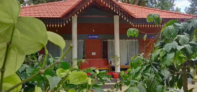 a red brick house with a red roof at RAI COTTAGE @ Coorg ,Suntikoppa in Suntikoppa