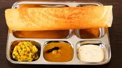 a lunch box with a sandwich and different types of food at Kunnampath Heritage Nalukettu in Trichūr