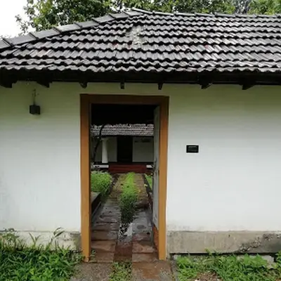 an open doorway to a white building with a roof at Kunnampath Heritage Nalukettu in Trichūr