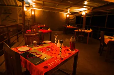 a table in a restaurant with a red table cloth at Nature Zone Jungle Resort- Experience the Wilderness & Adventure in Munnar