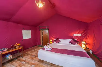a bedroom with a bed in a pink tent at Nature Zone Jungle Resort- Experience the Wilderness & Adventure in Munnar