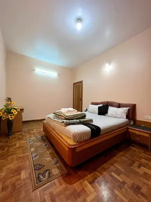 a bedroom with a large bed in a room at Chill Inn - Families Only in Ooty