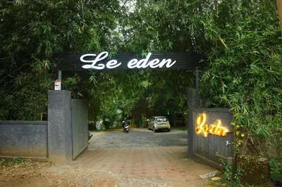 an open gate with a sign that says be eaten at Le Eden Premium Wayanad Pool Resort in Sultan Bathery