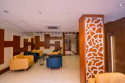 a lobby with couches and tables and chairs at JK HOTELS in Coimbatore