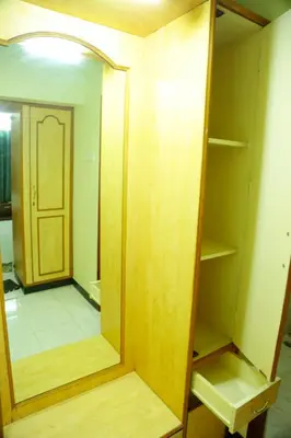 an empty closet with a mirror and a door at ZuriEL Suite GUEST HOUSE in Coimbatore