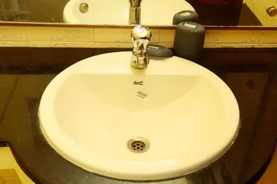 a bathroom sink with a silver faucet at ZuriEL Suite GUEST HOUSE in Coimbatore