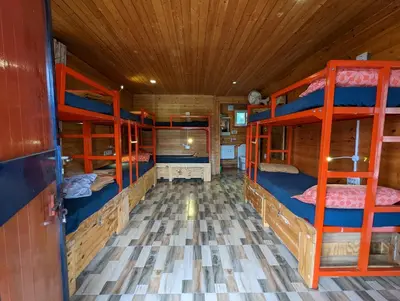a room with four bunk beds in a cabin at The Door to Nirvana Backpackers Hostel Kotagiri in Kotagiri