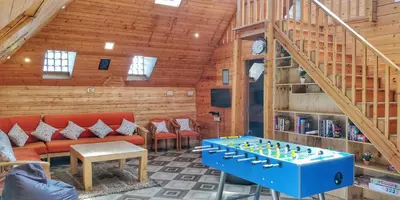 a living room with a couch and a chess board at The Door to Nirvana Backpackers Hostel Kotagiri in Kotagiri