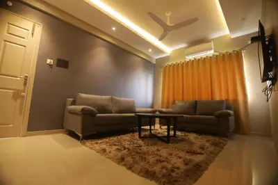 a living room with a couch and a table at Noor jehan's Grand Noor in Palakkad