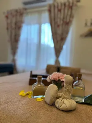 a table with a doll and two bottles on it at Machaan Wilderness Lodge Nagarahole in Srimangala