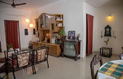a living room with a table and chairs at Homestay for Women in Coimbatore