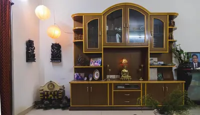 a large wooden hutch in a living room at Homestay for Women in Coimbatore