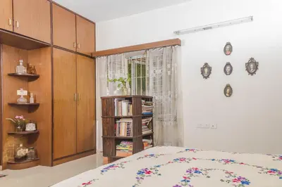 a bedroom with a bed and a book shelf at Homestay for Women in Coimbatore