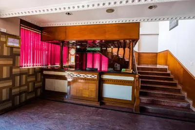 a staircase in a building with red curtains at Kallada Hotels and Resorts in Trichūr