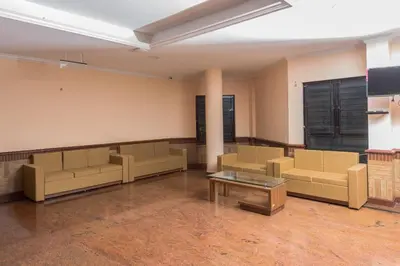 a waiting room with couches and a table in a room at Kallada Golden Hotel in Trichūr