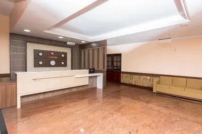 a large room with a waiting area and a large ceiling at Kallada Golden Hotel in Trichūr