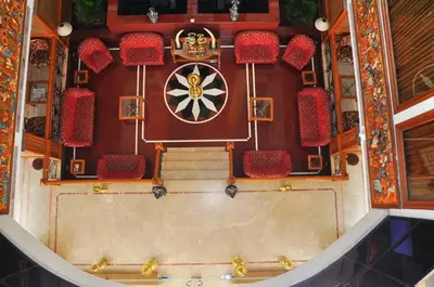 an overhead view of a theatre with red chairs and a stage at Mayura Residency in Guruvāyūr