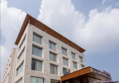 a building with a sky in the background at Hotel Preethi International in Mysore