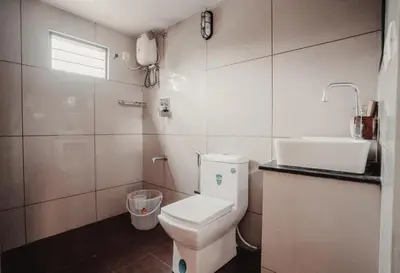 a bathroom with a toilet and a sink at Swasthigriha's Beach Homestay, Cherai in Cherai Beach