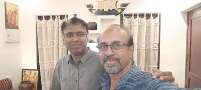 two men standing in front of a mirror at Swasthigriha's Beach Homestay, Cherai in Cherai Beach