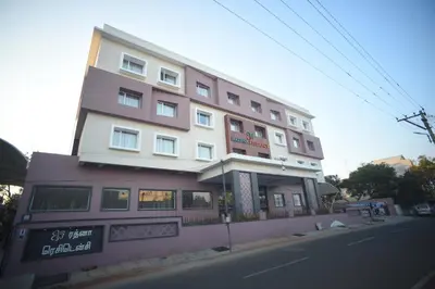 a tall building on the side of a street at Rathna Residency in Erode