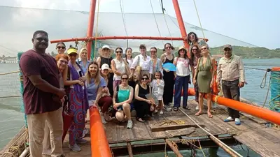 a group of people posing for a picture on a boat at Back Packers Cochin Villa in Cochin