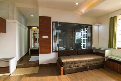 a living room with a couch and a window at Olives The Boutique Resort in Kalpetta