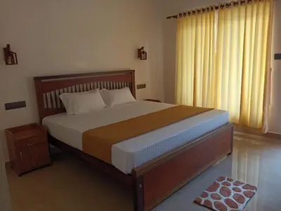 a bedroom with a large bed and a window at SAGAR BEACH VILLAS Home stay in Cherai Beach
