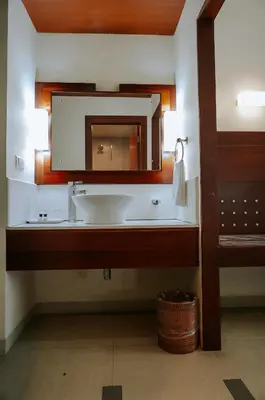 a bathroom with a sink and a mirror at Hotel Devaragam by K P Namboodiri's in Guruvāyūr