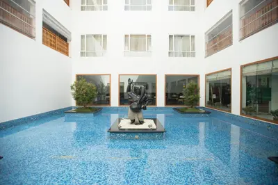 a lobby with a statue in the middle of a building at Hotel Devaragam by K P Namboodiri's in Guruvāyūr