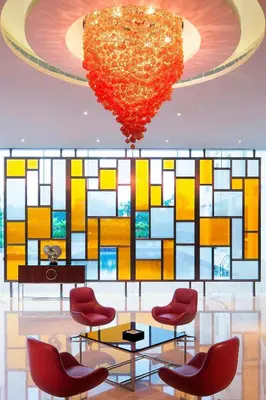 a room with chairs and a large heart hanging from a ceiling at Courtyard by Marriott Kochi Airport in Nedumbassery
