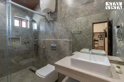 a bathroom with a sink and a shower and a toilet at Greenwood Bungalow Heritage In the heart of Ooty in Ooty