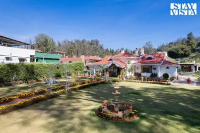 a park with a fountain in the middle of a yard at Greenwood Bungalow Heritage In the heart of Ooty in Ooty
