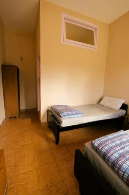 a bedroom with two beds and a window at REFLECTIONS Guest House in Ooty