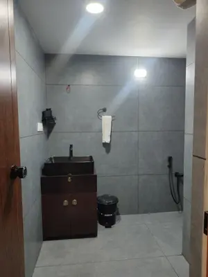 a bathroom with a sink and a shower at Maleyam Homestay Riverside in Kozhikode