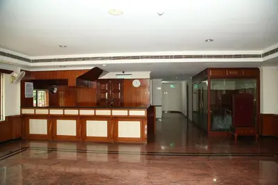 a large room with wooden cabinets and a glass door at Kallada Residency in Kodungallūr
