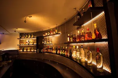 a bar with a lot of bottles on the wall at Copper Folia in Kozhikode