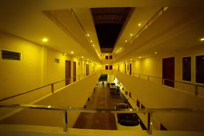 an empty hallway of a building with a glass floor at Hotel Wayanad Square in Mananthavady