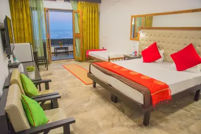 a bedroom with a large bed and a living room at 36 Palms Residency - Sea View Villa in Cochin