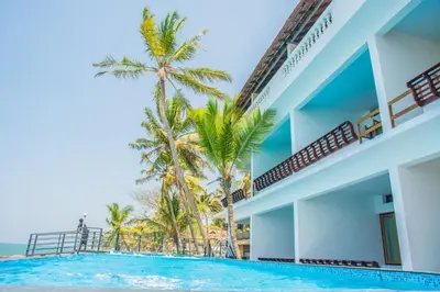 a view of a resort with a swimming pool and palm trees at 36 Palms Residency - Sea View Villa in Cochin