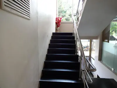 a stairway with black stairs and a window at Hotel Sky Lite in Coimbatore