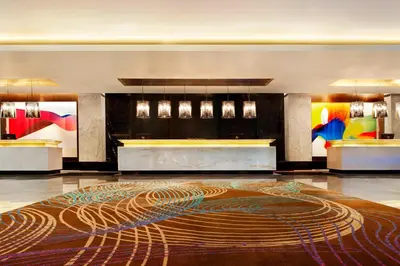 a lobby with a large rug on the floor at Le Meridien Coimbatore in Coimbatore