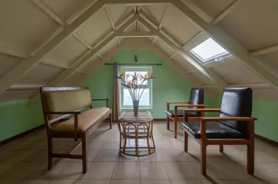 a room with two chairs and a bench and a window at Yellow Tulip Hill Side Luxury Villa by LexStays in Coonoor